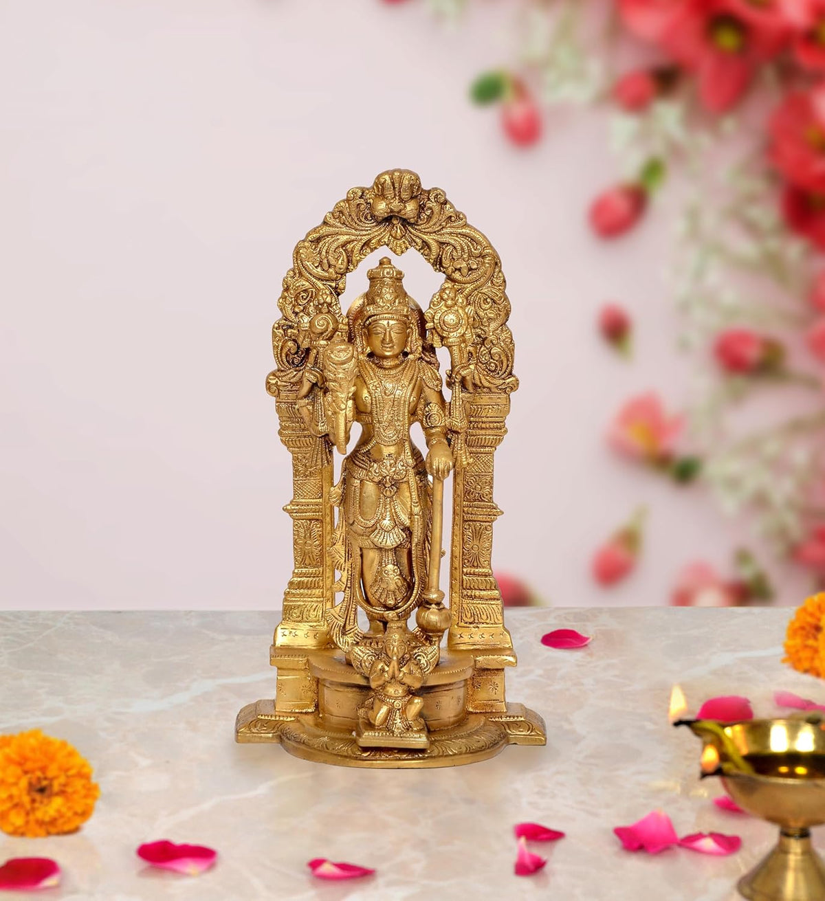 Brass standing four-armed Vishnu statue with ornate arch, on pedestal