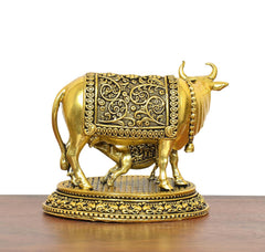 Gold brass cow and calf statue, close side view, ornate blanket and round base