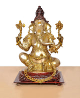 Brass Ganpati Bappa statue front view, ornate crown and four-armed seated figure