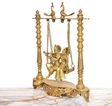 Brass Radha-Krishna swing idol, side view of hanging seat with detailed figures