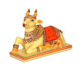 Resin Nandi cow idol in full pose, yellow with red saddle and gold ornaments
