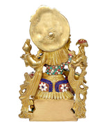Back view of brass Saraswati idol, engraved halo and decorated torso with jeweled bands