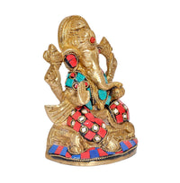 Brass Ganesha figurine in profile with red, turquoise, and white gem patterns