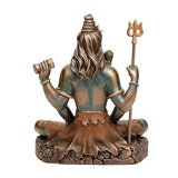 Resin Lord Shiva figurine rear view, long hair, trident raised, seated on rocky base