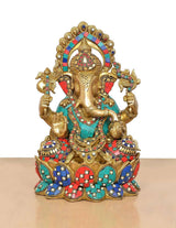 AONA brass Ganesha idol seated on ornate jewel-patterned base in teal, red, blue