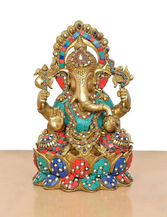 AONA brass Ganesha idol seated on ornate jewel-patterned base in teal, red, blue