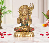 Brass Lord Shiva statue seated with trident, multicolored jewelry