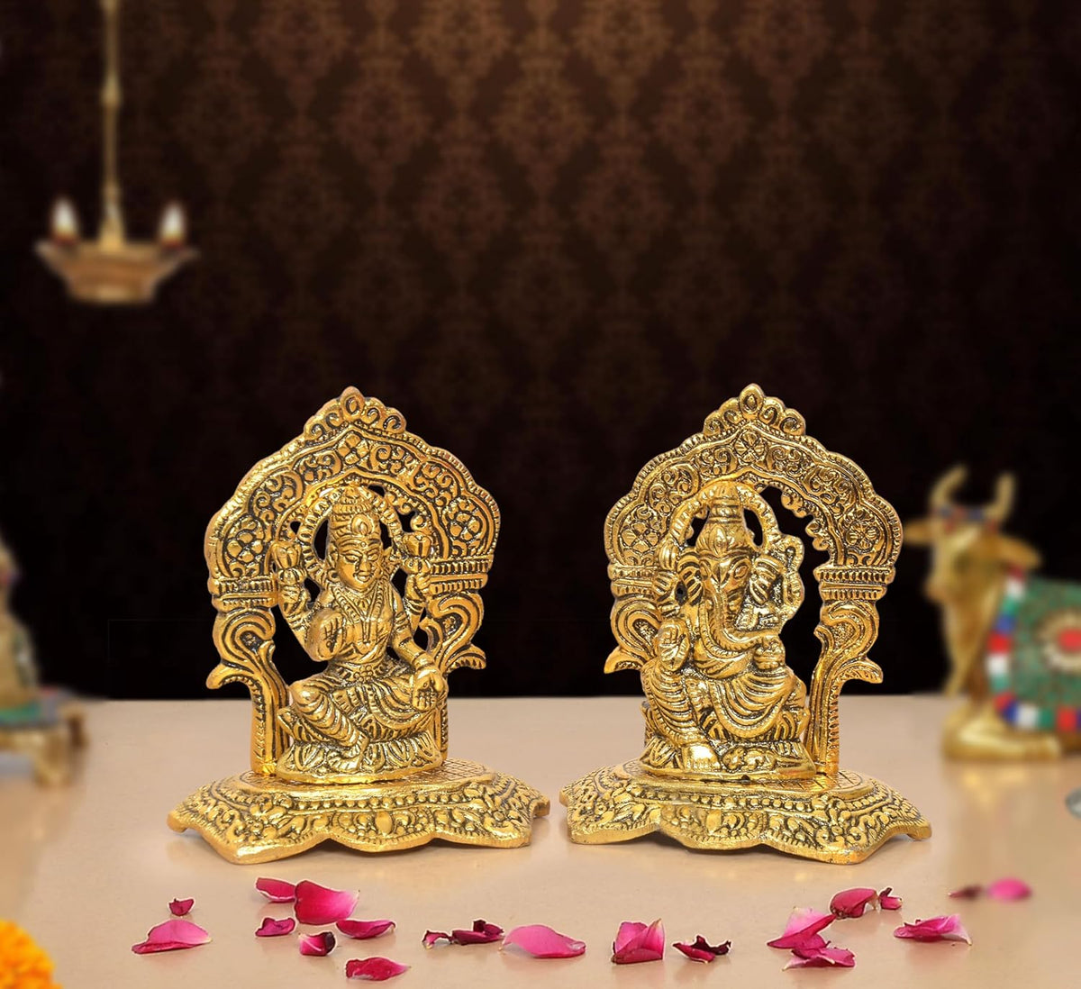 Golden metal Lakshmi and Ganesh statue pair with ornate seated figures on base