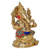 Brass Lord Ganesha idol three-quarter view, detailed crown, red sleeves, blue waist cloth.