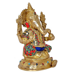 Brass Lord Ganesha idol three-quarter view, detailed crown, red sleeves, blue waist cloth.