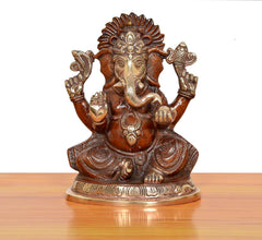 Brass Ganpati Bappa murti, front view; seated pose with trunk detail and decorative base.