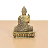 Bronze Buddha idol rear three-quarter view, Abhaya mudra hand, textured head and robe