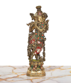 Lord Krishna brass statue with flute, standing pose, jeweled red, green, and blue accents.