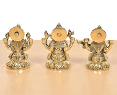 Brass Lakshmi Ganesha Saraswati idol set, rear view with circular back plaques
