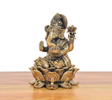 Bronze Lord Ganesha murti, side view showing trunk and four arms on lotus base
