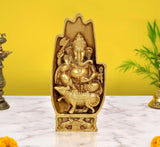 Golden brass Ganesha figurine in relief, blessing hand raised, seated on a mouse.