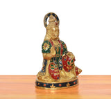 Brass Hanuman Ji murti, angled view with ornate halo and multicolor motifs on robe