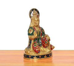 Brass Hanuman Ji murti, angled view with ornate halo and multicolor motifs on robe