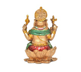 Back view resin Ganesha idol seated on lotus, green drape, red skirt, golden halo