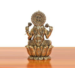 Rear view bronze Lakshmi idol with circular halo symbol, seated on lotus