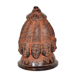 Brass Shiva nine-face stupa idol from side angle, engraved crown and multiple faces