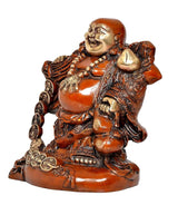 Seated Laughing Buddha figurine, brass-tone details on orange robe, side view