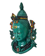 Green resin Shiva head mask statue, angled view with detailed earrings and necklace