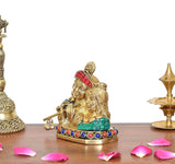 Brass Radha Krishna statue, close side view; teal sash, red crown, bead border