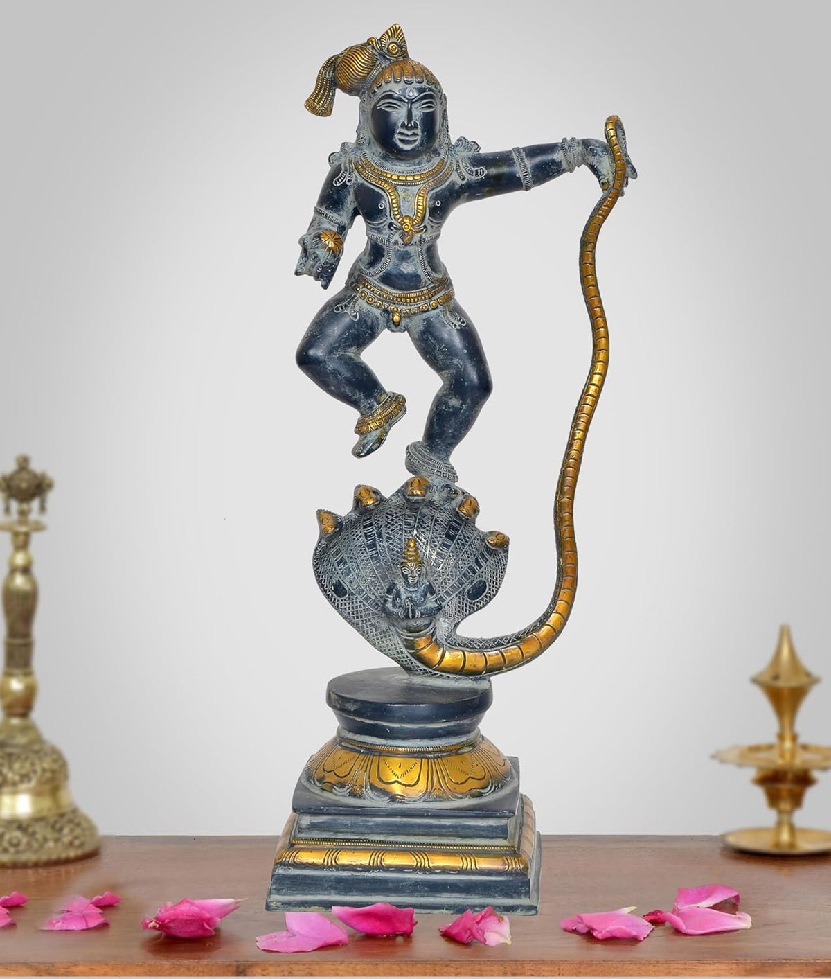 Krishna on Kaliya Naag brass statue, blue-black finish with gold accents, full figure