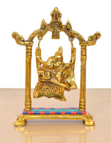 Gold metal Radha Krishna swing idol with platform base and decorative pillars