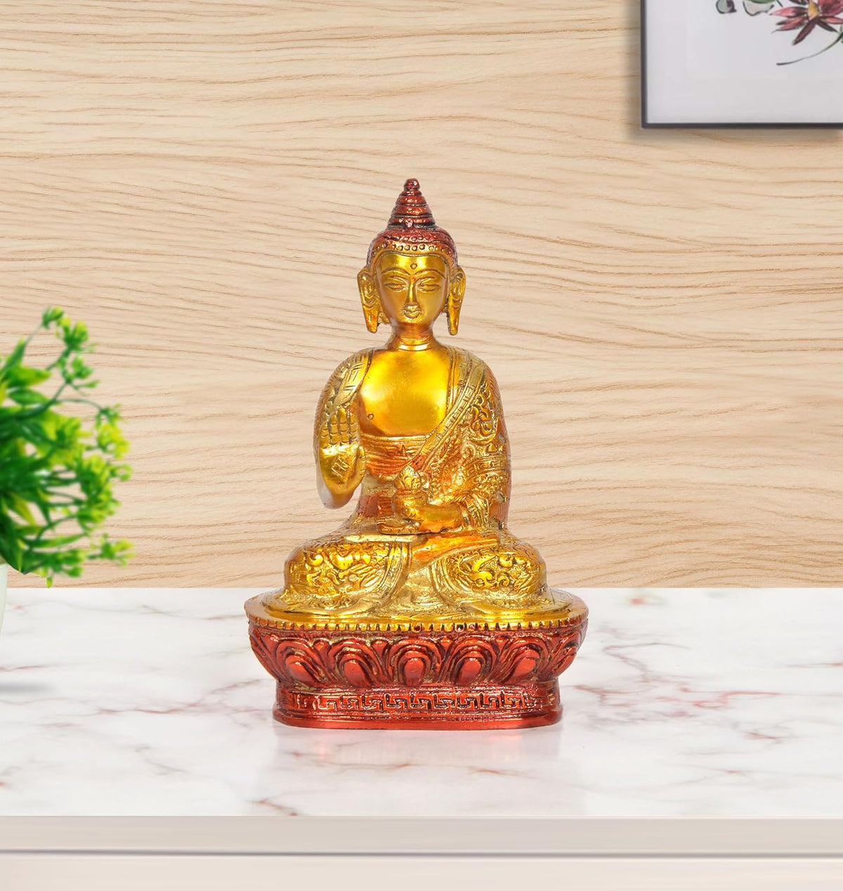 Brass Buddha statue in Abhaya mudra, seated on red ornate base (front view)