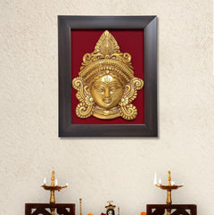 Brass Maa Durga face idol in dark wooden frame, gold relief on red backing