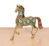 Brass running horse figurine in profile, green-and-gold patterned saddle