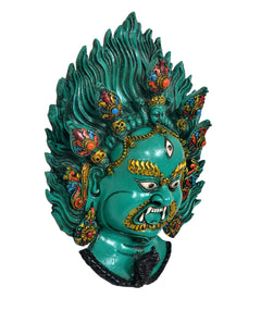Green resin Mahakal wall mask head, angry expression with gold, red and blue accents