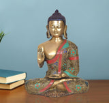 Brass Buddha statue meditating, raised hand mudra, enamel details in blue, green, red