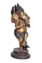 Side view brass Ganesha dancing idol, four arms, blackish base with carved pattern
