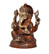 Ganesha idol statue, close side view with trunk and ornate crown, seated with hands up