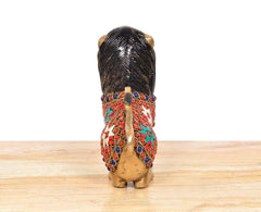 Back view of brass lion sculpture with multicolored jeweled waist and gold body