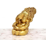 Brass Bal Ganesha murti, side view, raised head with detailed hair and ear ornaments