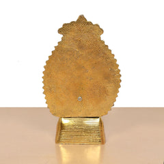 Gold metal Ganesha idol back view, textured embossed plate on pedestal