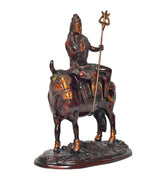 Shiva and Nandi religious statue, side view with trident raised and engraved saddle