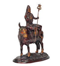 Shiva and Nandi religious statue, side view with trident raised and engraved saddle