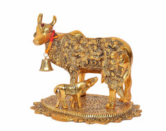 Kamdhenu cow with calf metal idol, red ribbon on neck and engraved patterned base
