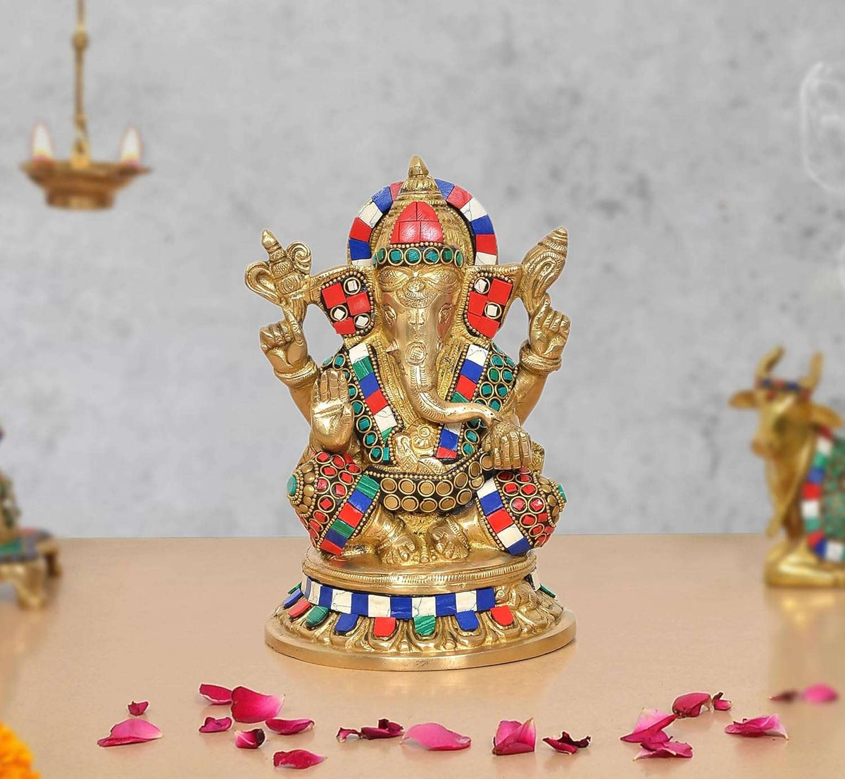 Brass Ganesha idol with multicolored ornaments, raised hands, front view (8 in)
