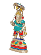 Brass Ganpati holding umbrella, side view; teal tunic, red shorts, golden accents
