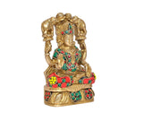 Gaja Lakshmi brass idol seated, colorful belt and patterned jewelry with gem accents.
