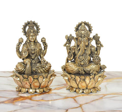 Front view of brass Lakshmi and Ganesh statues on lotus pedestals, ornate jewelry