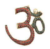 OM wall hanging sculpture in brass with red circular gems and teal rim details