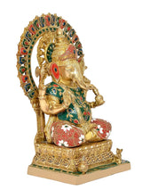 Profile view Brass Ganesha statue on pedestal with red patterned legs and green tunic