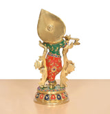 Back view Krishna brass idol with large gold halo and multicolor embroidered skirt